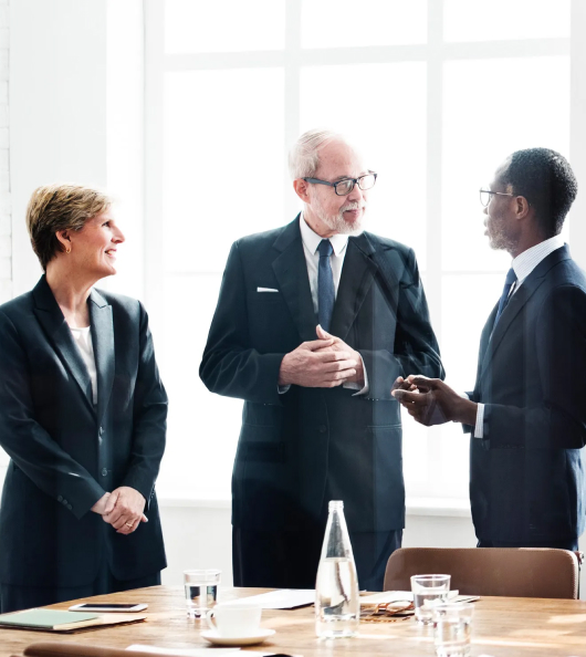 Three people in board room discussion